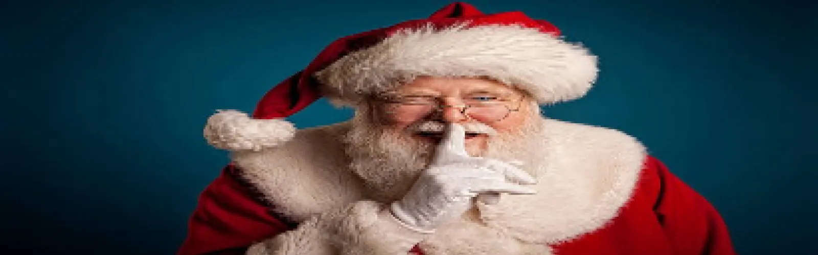 Santa with a quiet finger by his mouth on a blue background